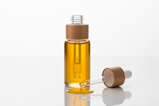 2oz dropper top of bottle oil with wood around the rim. the the top be off the bottle laying beside it with oil dripping out